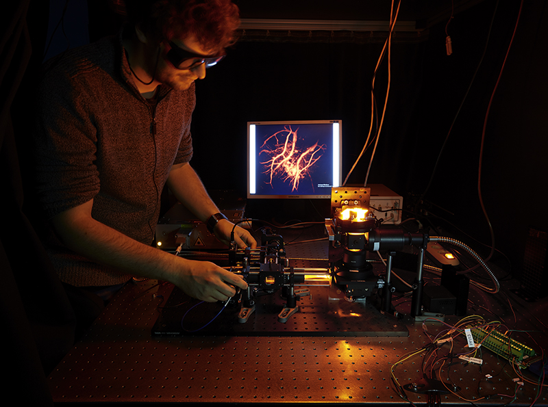 Jakub Czuchnowski working with the photoacoustic microscope