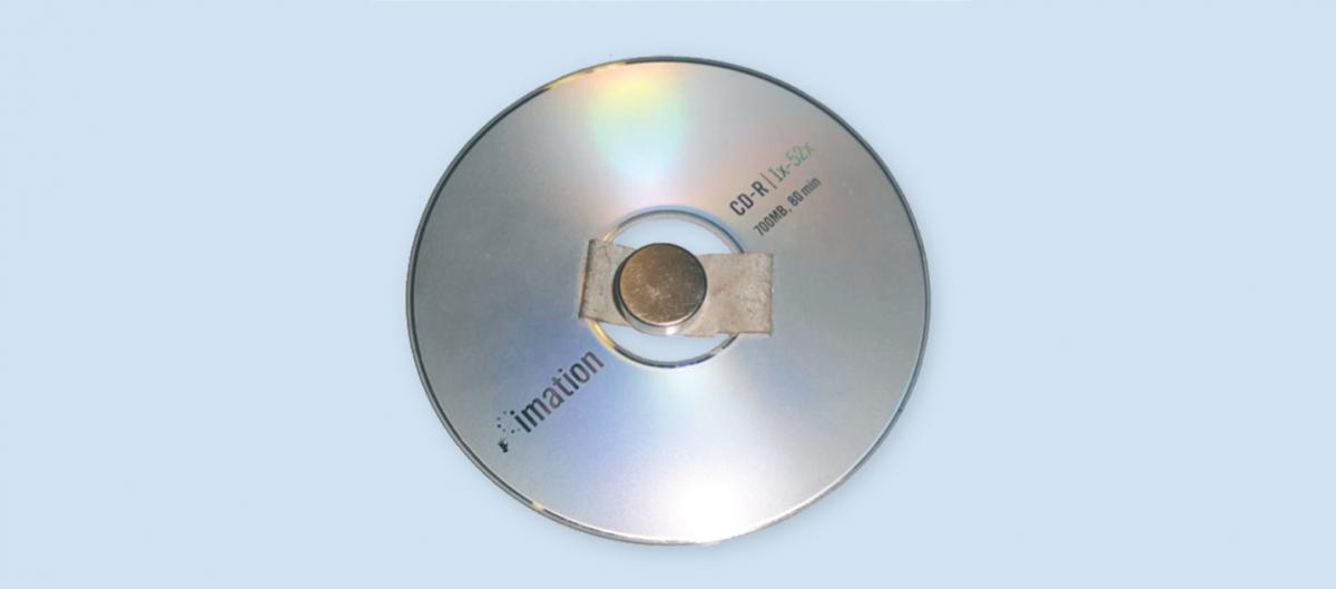 Figure 4: Using tape or glue, the magnet is fixed to a CD for support.