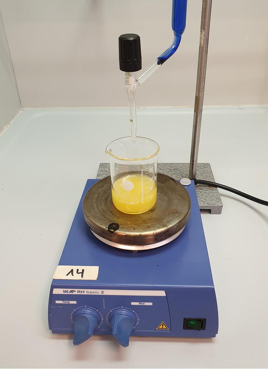 The burette set up for the titration with orange juice