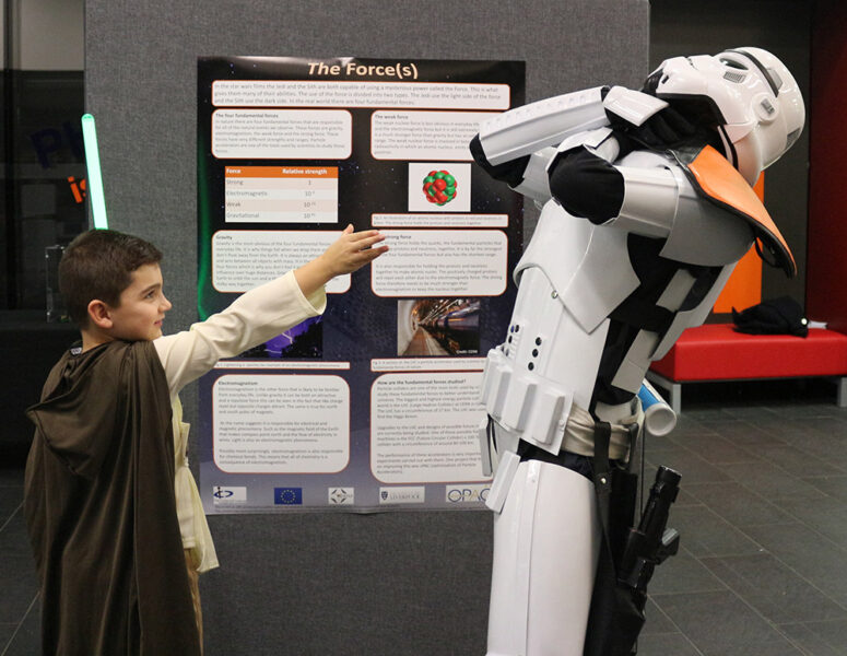 A child dressed as a Jedi attacks stormtrooper using the Force.