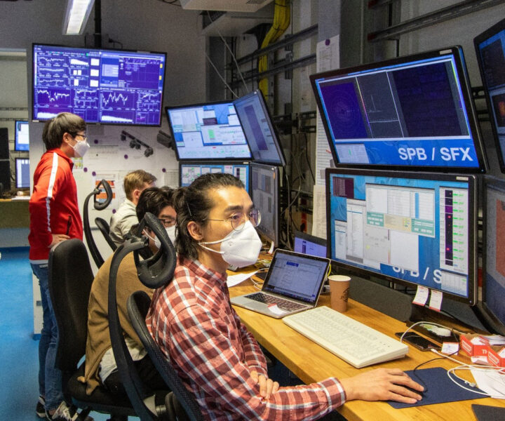 Scientists monitoring the experiment from the control room.