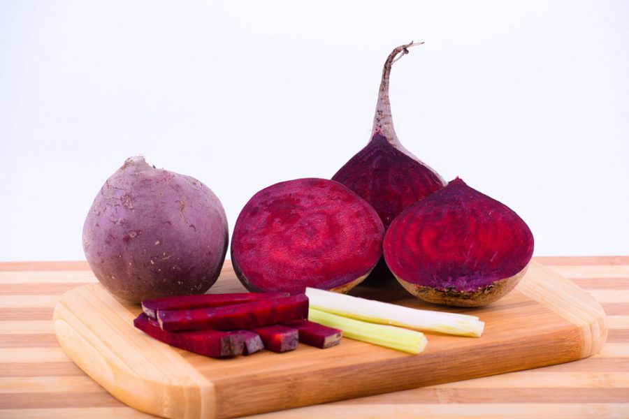 Beetroots on a cutting board showing a bright red colour.